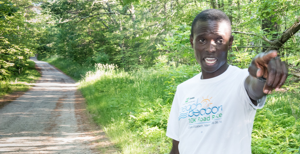 Marube Moninda points to the house on Spring Road in Auburn where he sought refuge after a pair of bears chased him earlier this year when he was out for a run. (Sun Journal file photo)