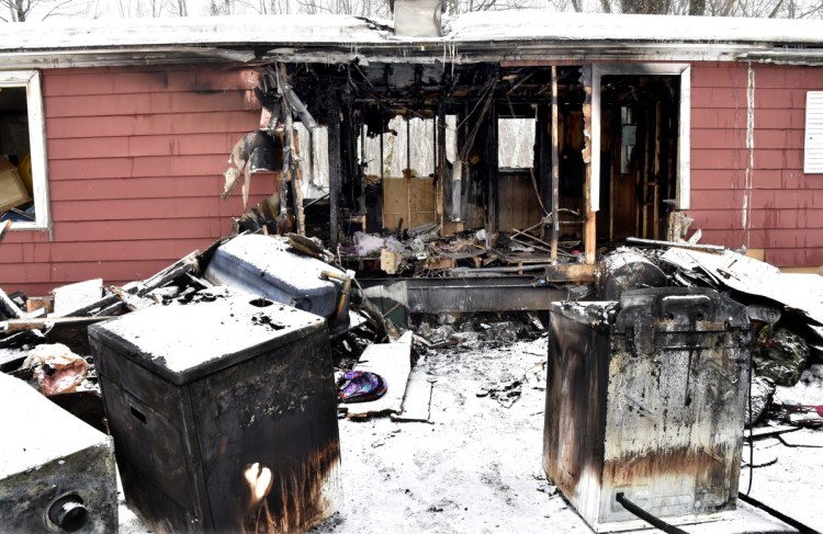 Burned appliances pulled through a gaping hole in this mobile home Tuesday populate the yard Wednesday at the site of a home fire in Cornville. Louis Wheeler Jr., the owner of the 733 East Ridge Road home in Cornville, said he wanted to credit firefighters for their efforts in a dangerous situation. "Those firefighters are animals," Wheeler said.