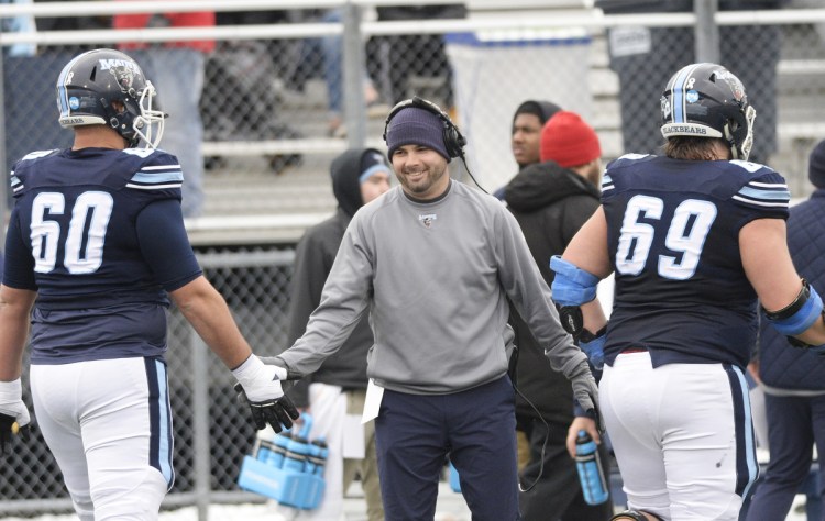 Joe Harasymiak congratulates University of Maine players during their NCAA playoff victory against Jacksonville State on Dec. 1, 2018. (Staff photo by Shawn Patrick Ouellette/Staff Photographer)