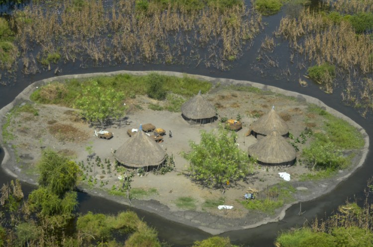 Thatched huts surrounded by floodwaters are seen from the air in Old Fangak county, Jonglei state, South Sudan in 2020.