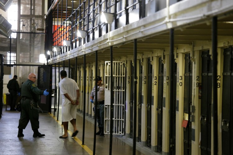 A condemned inmate is led out of his cell on death row in 2016 at San Quentin State Prison in San Quentin, Calif. 

