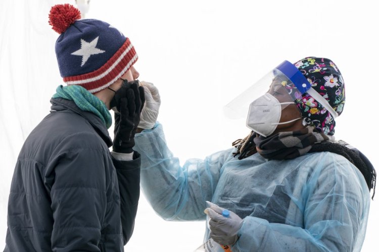 A man is swabbed for COVID-19 at a walk-up testing site at Farragut Square last month, just blocks from the White House in Washington. The number of new cases recorded on Monday topped 1 million, a figure that may reflect a backlog held up by reporting delays over the holiday weekend. 