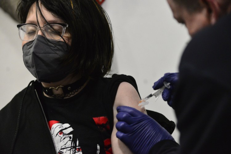 Riley Bredbeck, 13, of Westminster, Vt., gets a Pfizer COVID-19 booster during a vaccine clinic on Jan. 14 in Bellows Falls, Vt. Vermont is a national leader in the percentage of people who have been fully vaccinated and received a booster. 