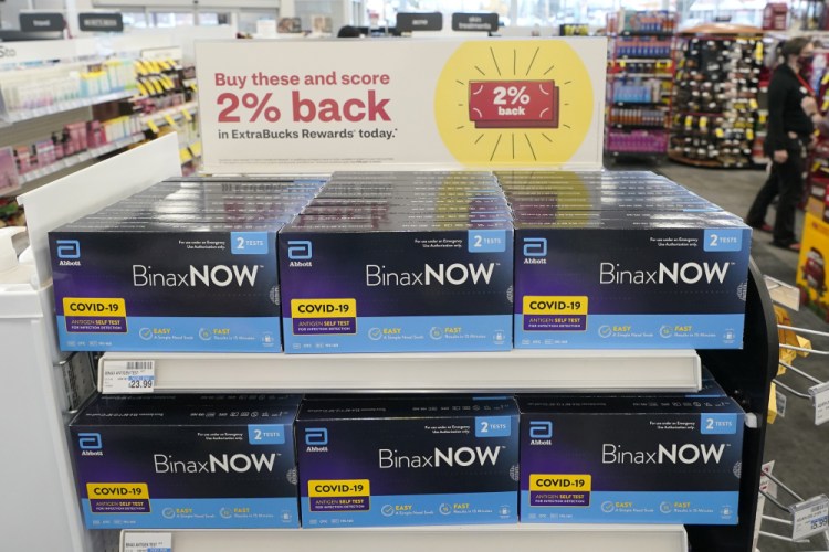 Boxes of BinaxNow home COVID-19 tests made by Abbott are shown for sale on Nov. 15, 2021, at a CVS store in Lakewood, Wash. 