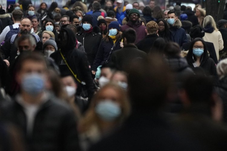 Shoppers walk down Oxford Street, Europe's busiest shopping street, in London, on Dec. 23.