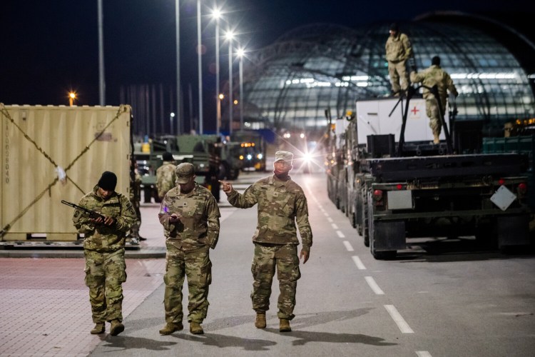 Soldiers from the U.S. Army's 82nd Airborne walk next to the G2A Arena, the division's main base, at Rzeszow-Jasionka airfield in Rzeszow, Poland, on Saturday. 