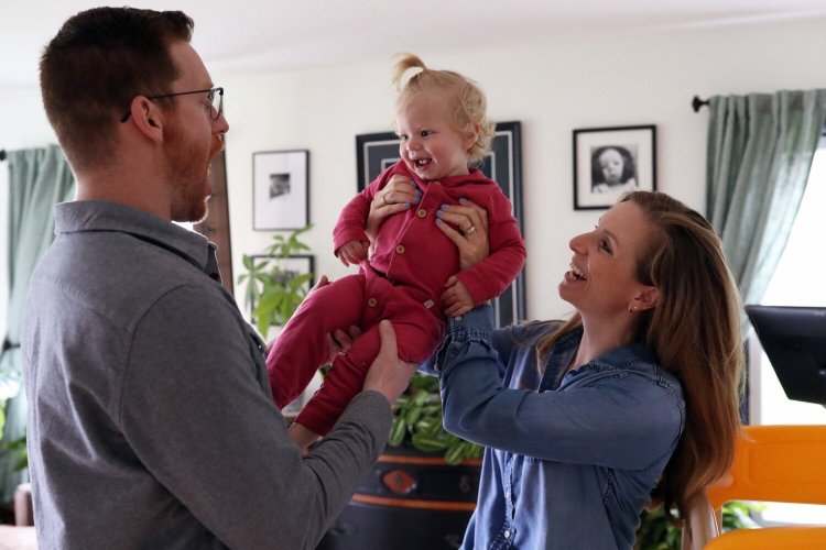 Dan and Molly Brubaker play with their daughter Ella, born in 2021. 